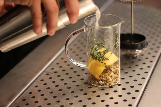After the cocktail components are prepared, the cocktail is poured into the French-Press to be infused with the botanicals.