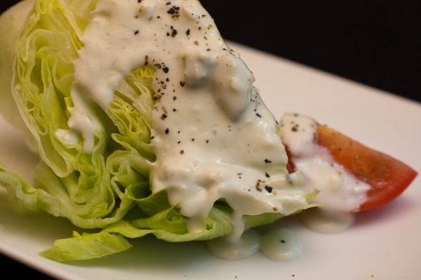 A wedge of crisp iceberg lettuce topped with bleu cheese dressing (only 3 ingredients!).  Some freshly ground pepper finishes our appetizer.