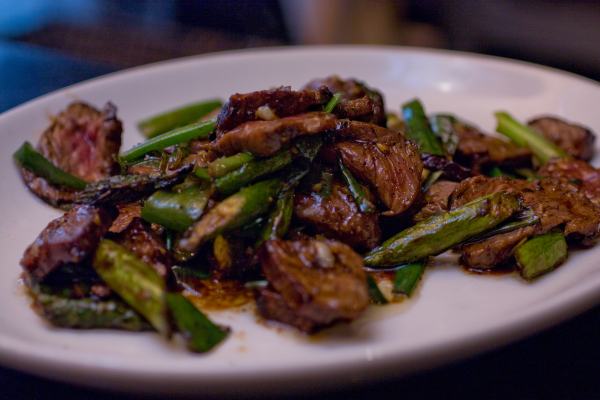 Mongolian Beef & Asparagus - Grilled Black Peppercorn Crusted N.Y. Strip, Stir Fry of Asparagus, Scallions, Sweet Soy, Chili Oil