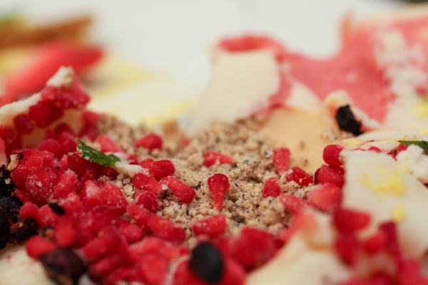 A raspberry has been dropped in liquid nitrogen and separated, tart little bits spread inside, along with other frozen fruity goodness.  Dried blueberries and crushed hazelnuts as well.  Chef Roche tasted and grinned, \"The lemon is strong.  It will take a little more work.\"