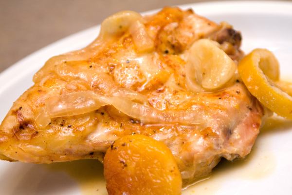 Baked chicken breast topped with apricots, garlic, and lemon slices.