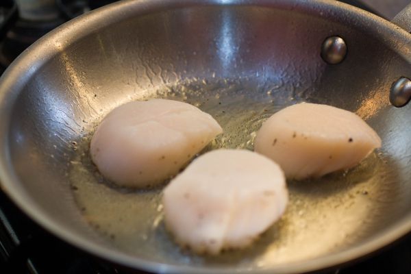 Step 4:  Right before you put the scallops in the pan, season them with some salt.  You do not want to do it any earlier than this because that will cause water to leach out of your scallop, thereby ruining that crust we\'re going for.  Don\'t overcrowd your pan or you\'ll drop the temperature of the pan too much to effectively brown the scallops.
