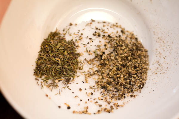 Salt, pepper, thyme.  How much? However much you like. You\'re going to want to liberally sprinkle the outside of the chicken so eyeball it.  You can\'t really go wrong here.