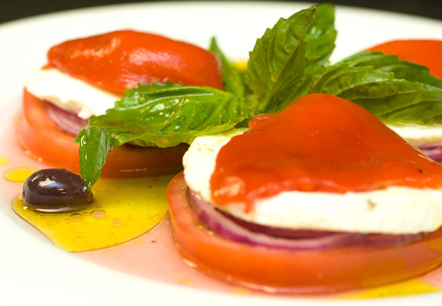Caprese Salad $9.00\r\nBeef steak sliced Tomatoes seasoned to perfection with thinly sliced Red Onion, Fresh Mozzarella, roasted Red Peppers, and Kalamata Olives in Red Wine Vinaigrette and Extra Virgin Olive Oil