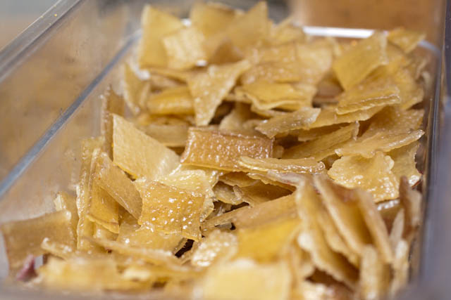 After the pork skin is cooked, it gets dehydrated into the hard, flat pieces you see here.  Tossed into oil, they expand into the pork rinds pictured earlier.