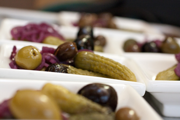 Rows of olives and cornichons for the charcuterie plates.