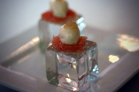 Amuse: Grapefruit cells with honey sorbet, chamomile agar atop a cold glass \"ice cube\".\r\n