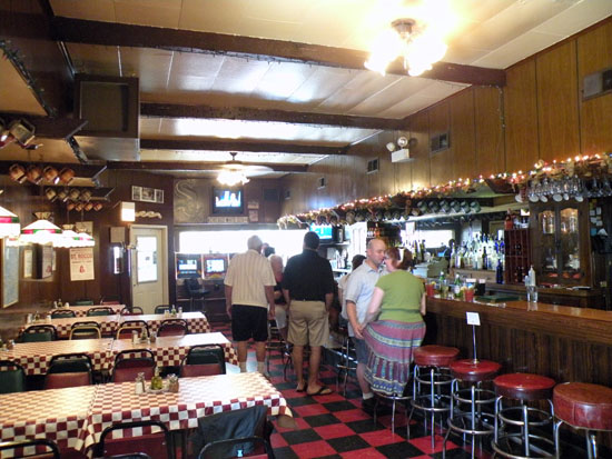 Check out the red-and-black checkered floors, the ceramic mugs hanging over head and that beautiful looking bar.