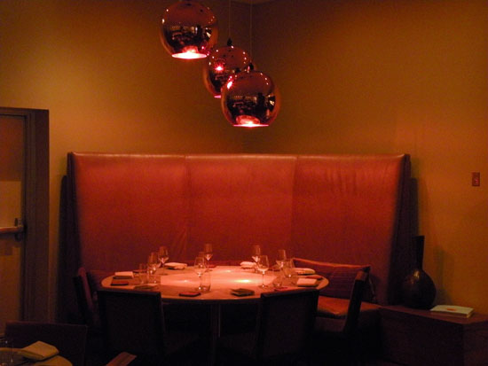 Note the polished copper light fixtures hanging over the corner \"party table,\" which has become a favorite of customers.