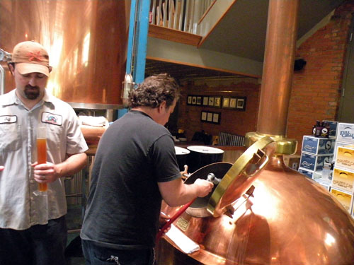 Sheahan prepares a sample of mash for weighing while Kahan tends to the boil.