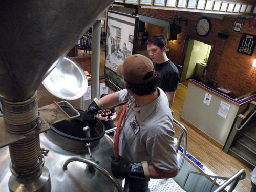 New Holland pub brewer Jeff Sheahan prepares for sparging while answering McAvena\'s questions.