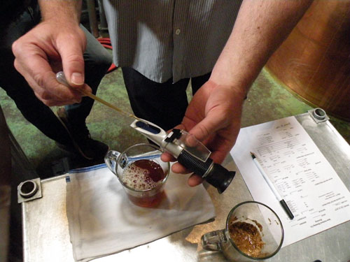 Sheahan measures the mash\'s density using a refractometer.