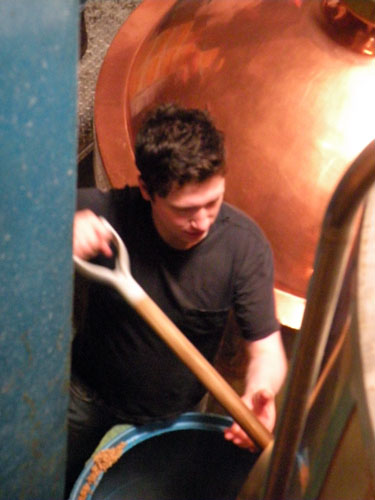 McAvena takes his turn cleaning out the mash tun.
