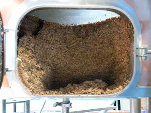 A close-up view of the spent brewers grain in the mash tun.