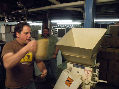 Kahan measures out some malt to be milled for brewing.
