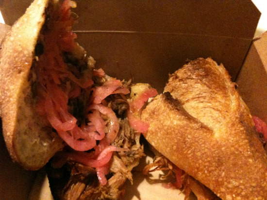 Cochinita Pibil torta: wood-roasted suckling pig with achiote, black beans, pickled onion, habanero salsa. That salsa has a heat index that is nuclear. Or \"nucular,\" if you\'re so inclined.