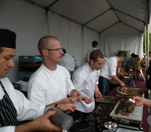 Lockwood\'s Phillip Foss serving up lamb with fig for attendees. In the background is Sepia\'s Andrew Zimmerman.