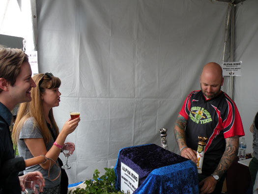 Three Floyds\' Lincoln Anderson pours a draft of Alpha King for an attendee.