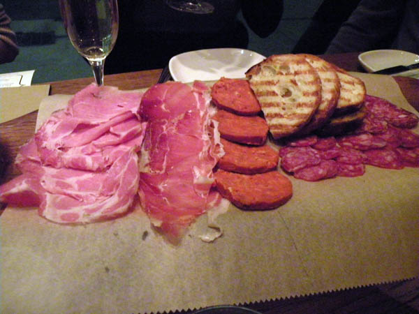 The \"Purple Pig\" platter: an assortment of five different cured meats and charcuterie.