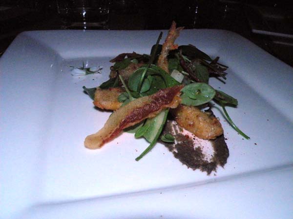 Salt and vinegar smelts with black hummus, guanciale, Werp Farm baby greens and espelette pepper from Paul Kahan.