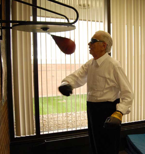 Sid was a former University of Illinois basketball star and fitness buff. Until a month or so before his death, he liked to work out in the gym he provided for his employees just upstairs from his souvenir-rich office. I had planned to use this as the \"closing\" picture as we called it on Life, of a Chicago icon, billionaire Sid Port. Still coming to work daily and punching away at age 96. He was my favorite man for all seasons. The kind of guy, Buddy Kalish recalls, who on overhearing a restaurant waitress say that her son\'s birthday was coming up and she was getting him a glove instead of the bike he really wanted, left her a $200 tip and left before she could thank him. (Art Shay)