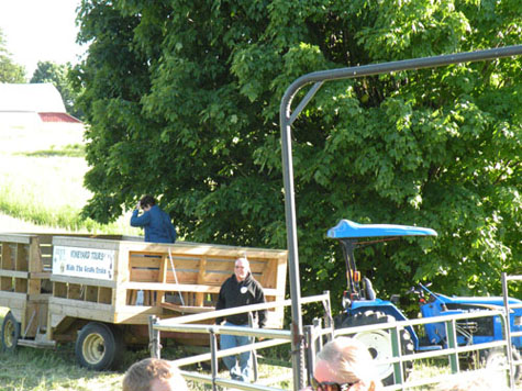 Bueltmann\'s neighbor, Doug Welsch from Fenn Valley Winery, and company show up by tractor and trailer to the farm dinner.