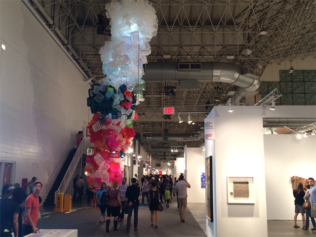 The entrance to the fair is dominated by B. Jessica Stockholder\'s \'Once Upon a Time,\' a towering cyclone of plastic containers reaching up to the roof. The piece is part of EXPO\'s large scale \'In Situ\' offerings. Photo by Josh Mogerman.