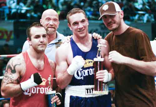 Mike Lee, in blue, receives his trophy from boxing phenom Kelly \"The Ghost\" Pavlik.