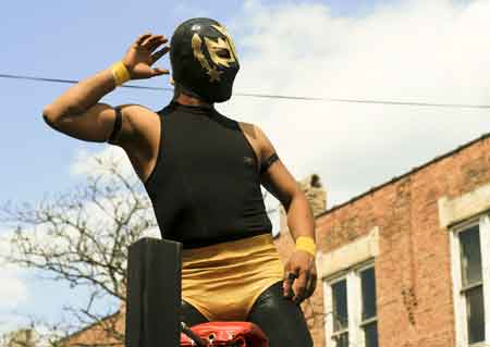 A lucha libre wrestler showing off before his match at Saturday\'s Mole de Mayo.