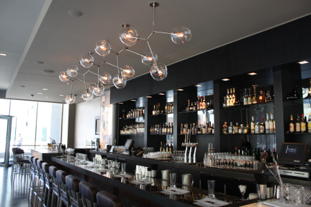 Sable\'s bar area, with a beautiful molecule-themed light fixture.