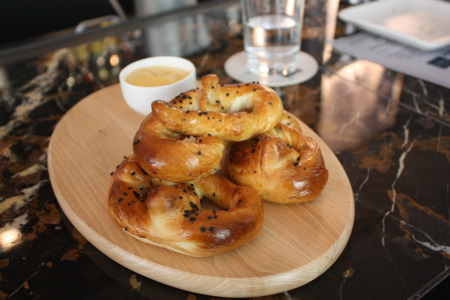 Homemade soft pretzels with cheese sauce.
