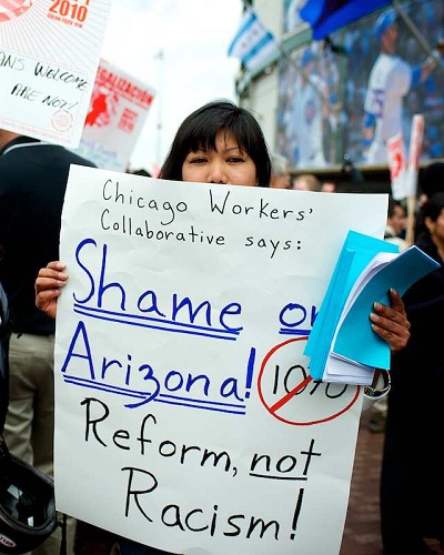 A member of the Chicago Worker\'s Collaborative protesting against the Arizona Immigration law at Wrigley Field.