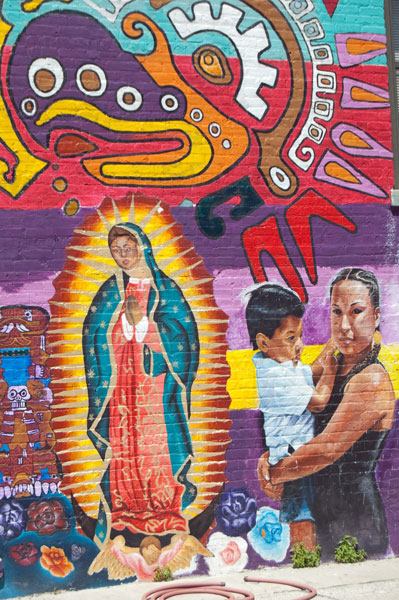 A brilliantly colored Virgin Mary on the side of the Casa AztlÃ¡n building in Pilsen.