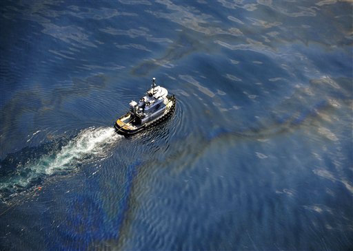 In this May 6, 2010 aerial image released by the U.S. Navy, a boat moves through oily water at the site of the Deepwater Horizon oil spill in the Gulf of Mexico.