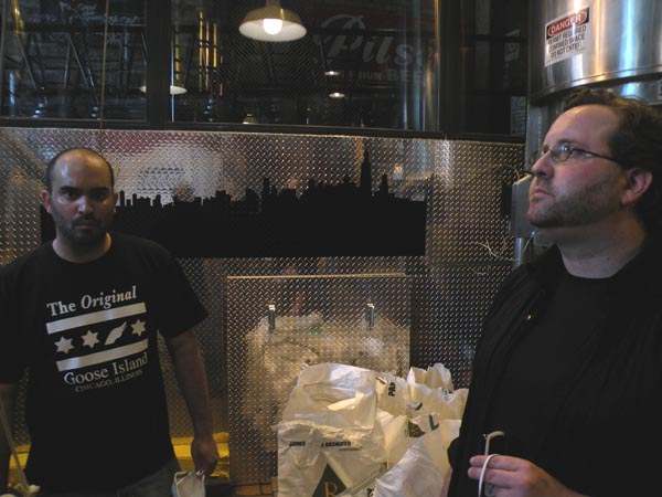 Jared Rouben (left) and Rod Markus sample some of the grain used in the brewing.
