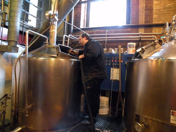 Markus takes a look at the freshly scrubbed sparging/whirlpool tank. Behind him is the mash tun.