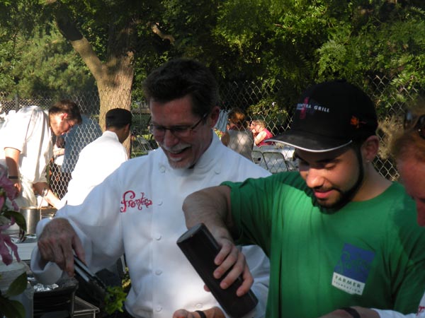 Rick Bayless serving up food for the guests.