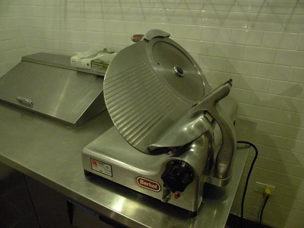 A meat slicer, ready for use. City Provisions will butcher and slice its meats in house.