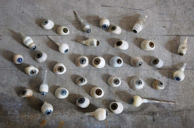 \"A collection of 33 unique hand blown human glass eyes from the 1880\'s. These come from a master glass makers shop in Germany and are in various states of production (as noted in elongated eye on lower right). Eyes have unique character to them and are each filled with intense detail such as veins and iris detail.\"