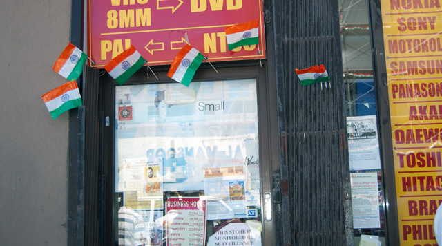 A shop owner proudly placed small Indian flags all around his door.