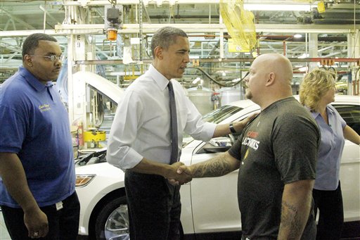 President Obama shakes hands with auto worker Michael McCullough, right, as Carlo Bishop, left, UAW President Local 551, looks on.