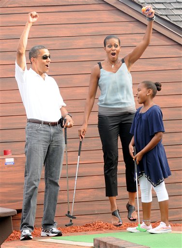 The Obama parents celebrate a D-Wade moment of triumph over their youngest daughter.