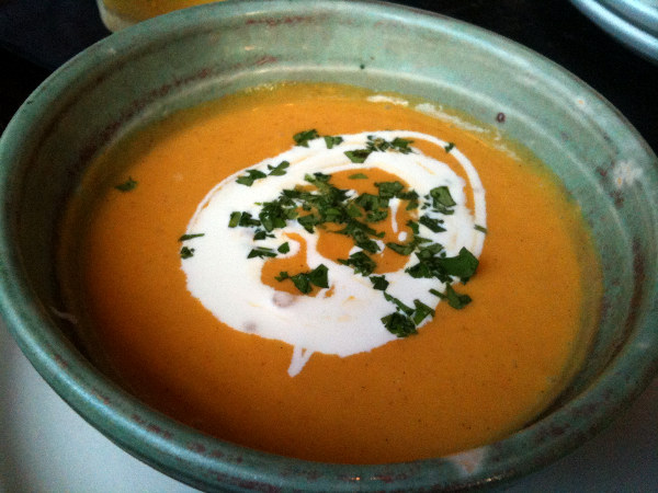Chilled yellow tomato and vanilla bean soup with yogurt.