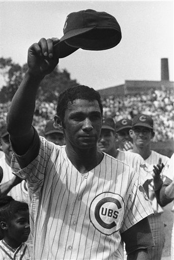 In this June 29, 1969, file photo, Chicago Cubs outfielder Billy Williams raises his cap on Billy Williams Day in Chicago. Williams appeared in his 896th consecutive game.