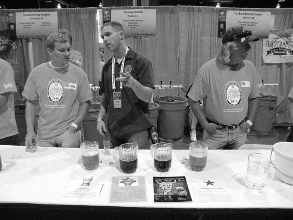 Flossmoor Station brewer Bryan Shimkos (center) speaks with GABF volunteers early during the Thursday session.
