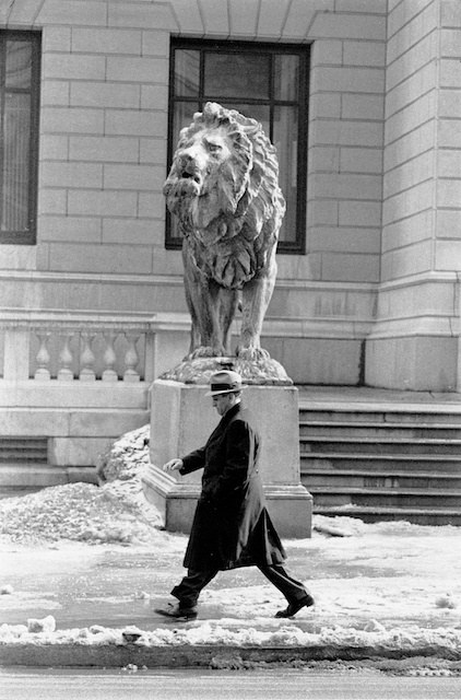 \<strong\>Big Tuna Passing Big Lion\<\/strong\>, 1958. I had photographed Chicago Mafia capo Tony Accardo, who headed the entire midwest Mafia operation according to the FBI, as he had testified for the first time at the Federal Courthouse. An informant had told me where Tony was being held- and I got a close-up frame of him that \<i\>Life\<\/i\> captioned  \"Mafia Emerges from the Shadows.\" He snarled at me and my writer, the fabled crime reporter Sandy Smith, all the way down in the back elevator. On the street he broke into a sprint and headed east for Michigan Avenue. I parked my gear and carrying one Nikon with 400 mm lens- a preposterous F 9 Novoflex- I trailed him from the far side of Michigan. I could see the picture I wanted coming up and I got my picture. I used it as the theme picture of my show at the Cultural Center one year and - truth to tell, a member of the family or an admirer - bought six prints for cash. \"Tony liked the picture,\" she told my rep. \r\n\r\n