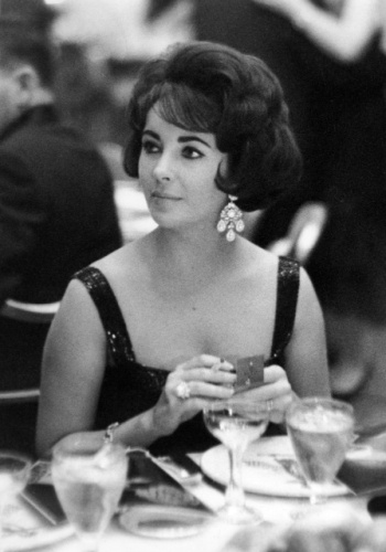 Elizabeth Taylor was in town that first week of January in 1960 to lead the celebration and introduction, if not the resurrection of her late husband Mike Todd\'s ill-fated project \"Smell-O-Vision.â  The movie that would be the centerpiece of the fete was called \"The Scent of Mystery\" and veteran villain Peter Lorre would figure in the creaky plot also involving Denholm Elliott. (When the characters walked into an orange grove- a basement squad of technicians would waft the scent of oranges into the theater, etc. It was an old idea whose time hadn\'t come until Todd threw ten million bucks at it.)\r\n