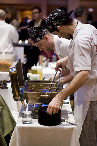 Chefs from the Purple Pig plating their pigs\' tails braised in balsamic, which disappeared so fast, we didn\'t get to try it.