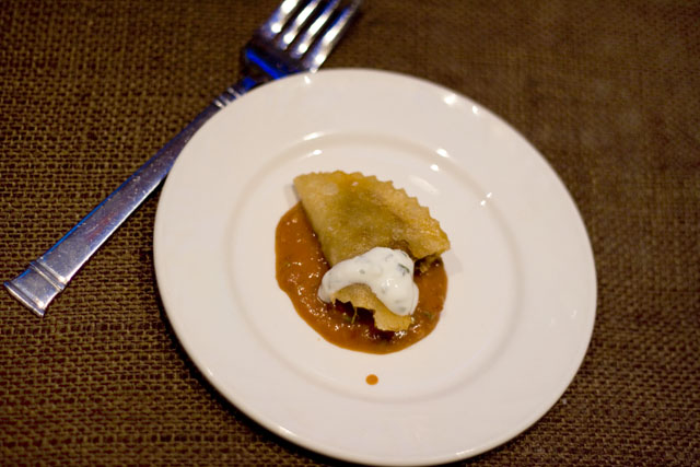 A luscious, smoky goat empanada from event \"headliner\" and Girl & the Goat chef, Stephanie Izard.