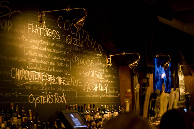 Chalkboards listing menu items back the expansive bar at Hubbard Inn.